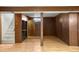Spacious basement with wood paneled walls, stairs and hard wood floors at 2683 E 90Th Pl, Thornton, CO 80229