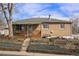 Traditional brick home with covered front porch, gray roof, and manicured landscaping offers classic charm and appeal at 2683 E 90Th Pl, Thornton, CO 80229