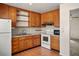 Traditional kitchen with wood cabinets, vintage white appliances and double sink at 2683 E 90Th Pl, Thornton, CO 80229