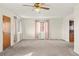 Bright living room featuring neutral walls, carpeted floors, and a stylish ceiling fan, creating a cozy atmosphere at 2683 E 90Th Pl, Thornton, CO 80229
