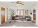 Bright living room featuring neutral walls, carpeted floors, and a stylish ceiling fan, creating a cozy atmosphere at 2683 E 90Th Pl, Thornton, CO 80229