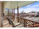 Inviting front porch with swing, decorative wood railing, and neighborhood views at 2683 E 90Th Pl, Thornton, CO 80229