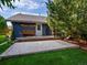Backyard features a patio area and deck with a wooden bench against the backdrop of a manicured lawn at 5884 S Hanover Way, Greenwood Village, CO 80111