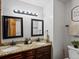 Bathroom featuring double sinks, granite countertops, elegant mirrors, and brushed nickel fixtures, creating a luxurious feel at 5884 S Hanover Way, Greenwood Village, CO 80111