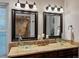 Bathroom featuring double sinks with glass basins and sconce lighting at 5884 S Hanover Way, Greenwood Village, CO 80111
