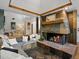 Living room with stone fireplace, cozy seating, and an open view to other living spaces at 5884 S Hanover Way, Greenwood Village, CO 80111
