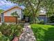 Charming home exterior featuring a well-maintained lawn, mature trees, and a welcoming walkway at 5884 S Hanover Way, Greenwood Village, CO 80111
