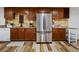 Kitchenette features stainless steel refrigerator and wooden cabinets at 5884 S Hanover Way, Greenwood Village, CO 80111