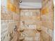 Beautiful shower with travertine tile, including built in shelves and a modern shower head at 5884 S Hanover Way, Greenwood Village, CO 80111