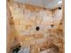 Tiled shower with travertine style block tiles and a black shower head at 5884 S Hanover Way, Greenwood Village, CO 80111