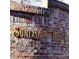 Community sign, reading 'Sundance Hills' on a brick retaining wall at 5884 S Hanover Way, Greenwood Village, CO 80111
