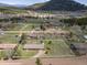 Aerial view of a ranch home on a large lot, surrounded by beautiful landscaping and mountain scenery at 26063 Morris Ave, Conifer, CO 80433