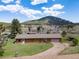 Aerial view of a charming ranch home in a serene mountain setting with beautiful trees at 26063 Morris Ave, Conifer, CO 80433