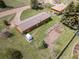 This aerial view showcases the home, garden plots, and yard, nestled in a tranquil environment at 26063 Morris Ave, Conifer, CO 80433