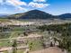 Expansive aerial shot showcases the homes, landscape, and location near wooded areas at 26063 Morris Ave, Conifer, CO 80433