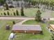 Birds-eye view of the cozy house and yard surrounded by trees and a winding driveway at 26063 Morris Ave, Conifer, CO 80433