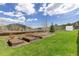 Property with garden beds and a greenhouse, perfect for gardening enthusiasts at 26063 Morris Ave, Conifer, CO 80433