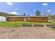Home featuring a spacious yard, complemented by garden beds and lush grass at 26063 Morris Ave, Conifer, CO 80433