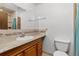 Bathroom features a single sink vanity with granite countertops, tile backsplash, and a tile floor at 26063 Morris Ave, Conifer, CO 80433