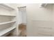 Walk-in closet with white shelving on both sides, providing ample storage space at 26063 Morris Ave, Conifer, CO 80433