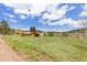 Spacious lot with grassy field and detached garage, perfect for country living and outdoor activities at 26063 Morris Ave, Conifer, CO 80433
