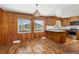 Eat-in kitchen features wood paneling, flooring, stainless steel appliances, and views of the surrounding hillside at 26063 Morris Ave, Conifer, CO 80433