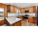 Bright kitchen boasts stainless steel appliances, tile backsplash, wooden cabinetry, and modern countertops at 26063 Morris Ave, Conifer, CO 80433