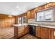 Kitchen and breakfast nook with wood cabinetry and tile countertops with views of the mountains at 26063 Morris Ave, Conifer, CO 80433