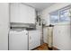 Functional laundry area with modern washer, dryer, and ample storage cabinets at 26063 Morris Ave, Conifer, CO 80433