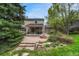 Expansive backyard features a patio with a fire pit, pond, and lush landscaping at 7100 S Hudson Cir, Centennial, CO 80122