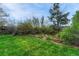 Lush backyard features green grass, trees, and bushes at 7100 S Hudson Cir, Centennial, CO 80122