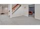 Finished basement with stairs and a glimpse into an adjacent office space at 7100 S Hudson Cir, Centennial, CO 80122
