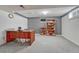 Spacious basement features a large wooden desk and built-in bookshelves for ample storage at 7100 S Hudson Cir, Centennial, CO 80122