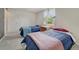 Well-lit bedroom featuring two beds, a cozy carpet and natural light from the window at 7100 S Hudson Cir, Centennial, CO 80122