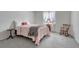Inviting bedroom with soft gray carpet, a pink bedspread, and a window view at 7100 S Hudson Cir, Centennial, CO 80122