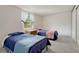 Bright bedroom features two beds, soft carpet, and a window with a lush green view at 7100 S Hudson Cir, Centennial, CO 80122