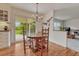 Breakfast nook with wood floors, chandelier, a sliding door leading to the backyard, and lots of natural light at 7100 S Hudson Cir, Centennial, CO 80122