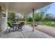 Relaxing covered patio includes a round table with chairs and a stone fire pit for outdoor gatherings at 7100 S Hudson Cir, Centennial, CO 80122