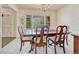 Inviting dining room with large windows and a traditional wooden table set for a meal at 7100 S Hudson Cir, Centennial, CO 80122