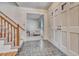 Inviting entryway featuring slate floors, a wood staircase, and decorative front doors at 7100 S Hudson Cir, Centennial, CO 80122