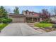 Charming two-story home with brick exterior, landscaped yard, and a two car garage at 7100 S Hudson Cir, Centennial, CO 80122
