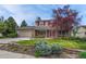 Charming two-story home with brick exterior, landscaped yard, and a two car garage at 7100 S Hudson Cir, Centennial, CO 80122