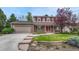 Charming two-story home with brick exterior, landscaped yard, and a two car garage at 7100 S Hudson Cir, Centennial, CO 80122