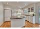 Bright kitchen with white cabinets, center island, and stainless steel appliances at 7100 S Hudson Cir, Centennial, CO 80122