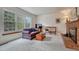 Comfortable living room featuring a cozy fireplace and large windows for bright, natural light at 7100 S Hudson Cir, Centennial, CO 80122