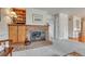 Charming living room features a cozy brick fireplace, built-in bookshelves, and neutral carpet throughout at 7100 S Hudson Cir, Centennial, CO 80122