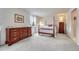 Comfortable bedroom with a wooden four-poster bed, classic dresser, and soft carpet at 7100 S Hudson Cir, Centennial, CO 80122
