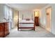 Bright main bedroom with a four-poster bed, plush carpeting, and ample natural light at 7100 S Hudson Cir, Centennial, CO 80122