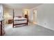 Cozy main bedroom featuring a four-poster bed, soft carpet, and a doorway to the ensuite at 7100 S Hudson Cir, Centennial, CO 80122