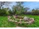 Beautiful rock-lined pond surrounded by lush landscaping, creating a tranquil outdoor oasis at 7100 S Hudson Cir, Centennial, CO 80122